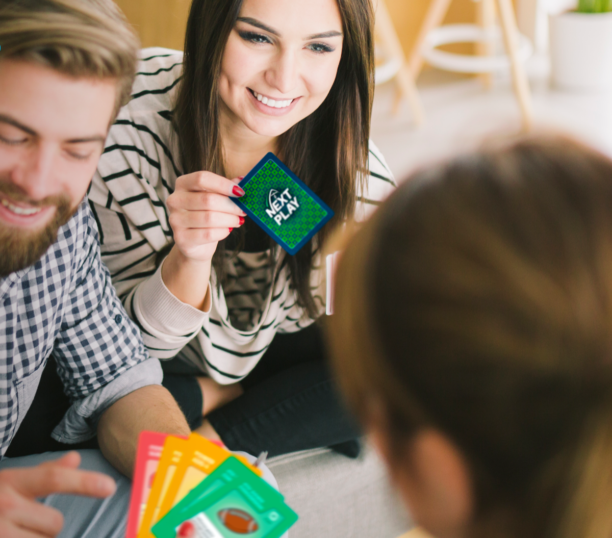 Friends playing the Next Play card game